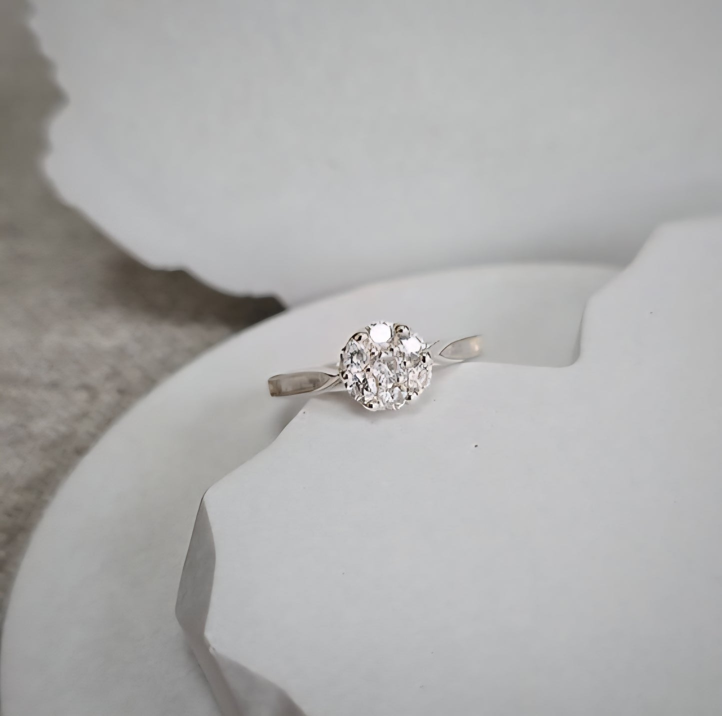 Silver ring with a cz on a white surface