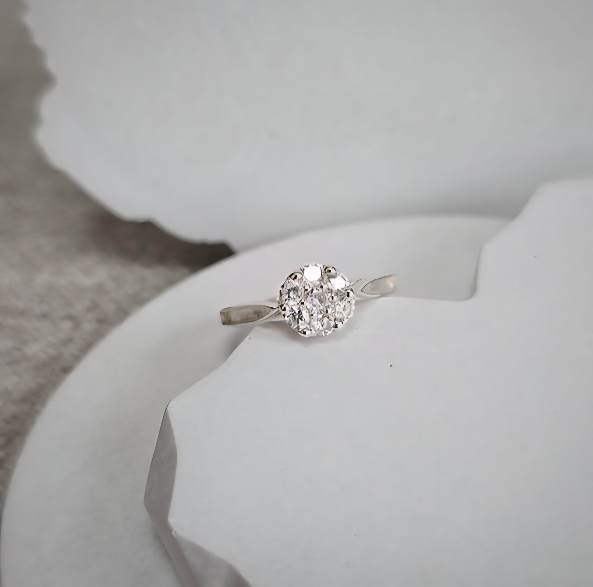 Silver ring with a cz on a white surface