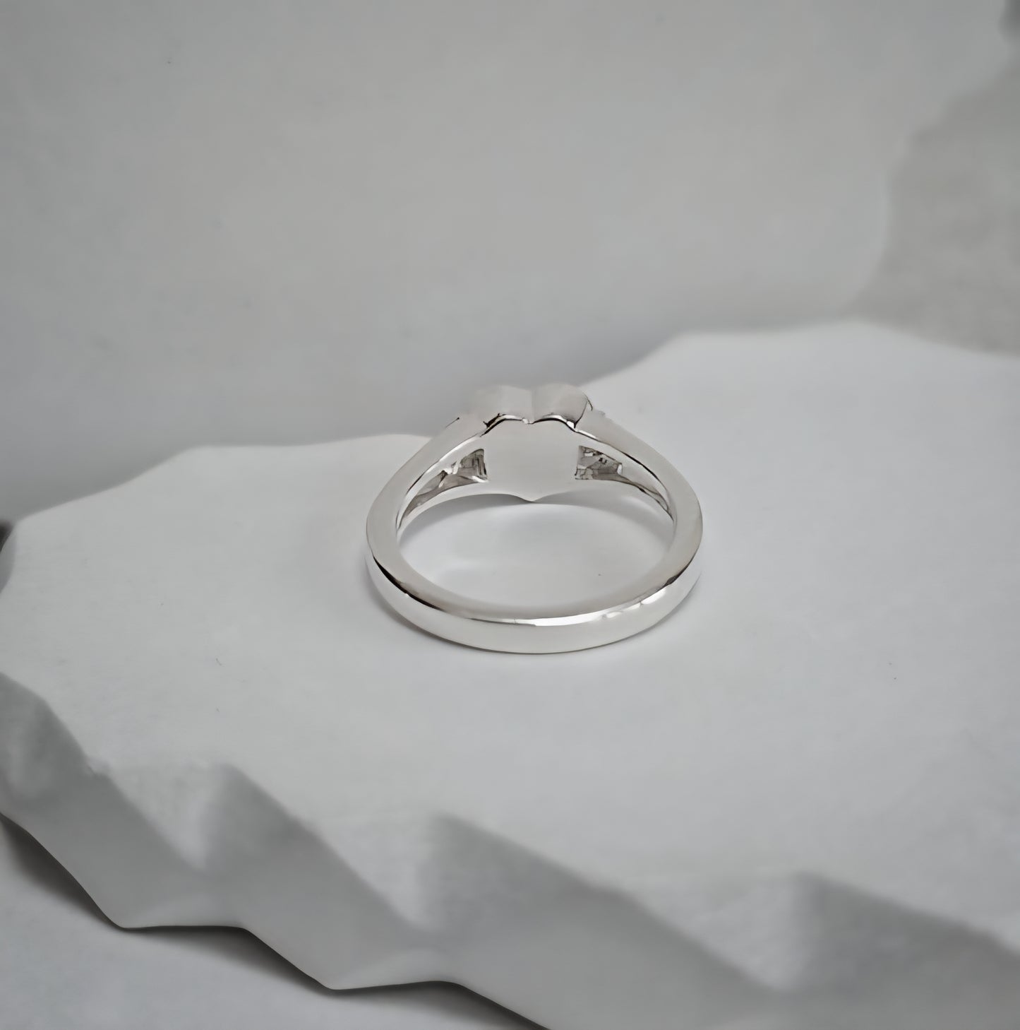 Silver ring on a textured gray surface