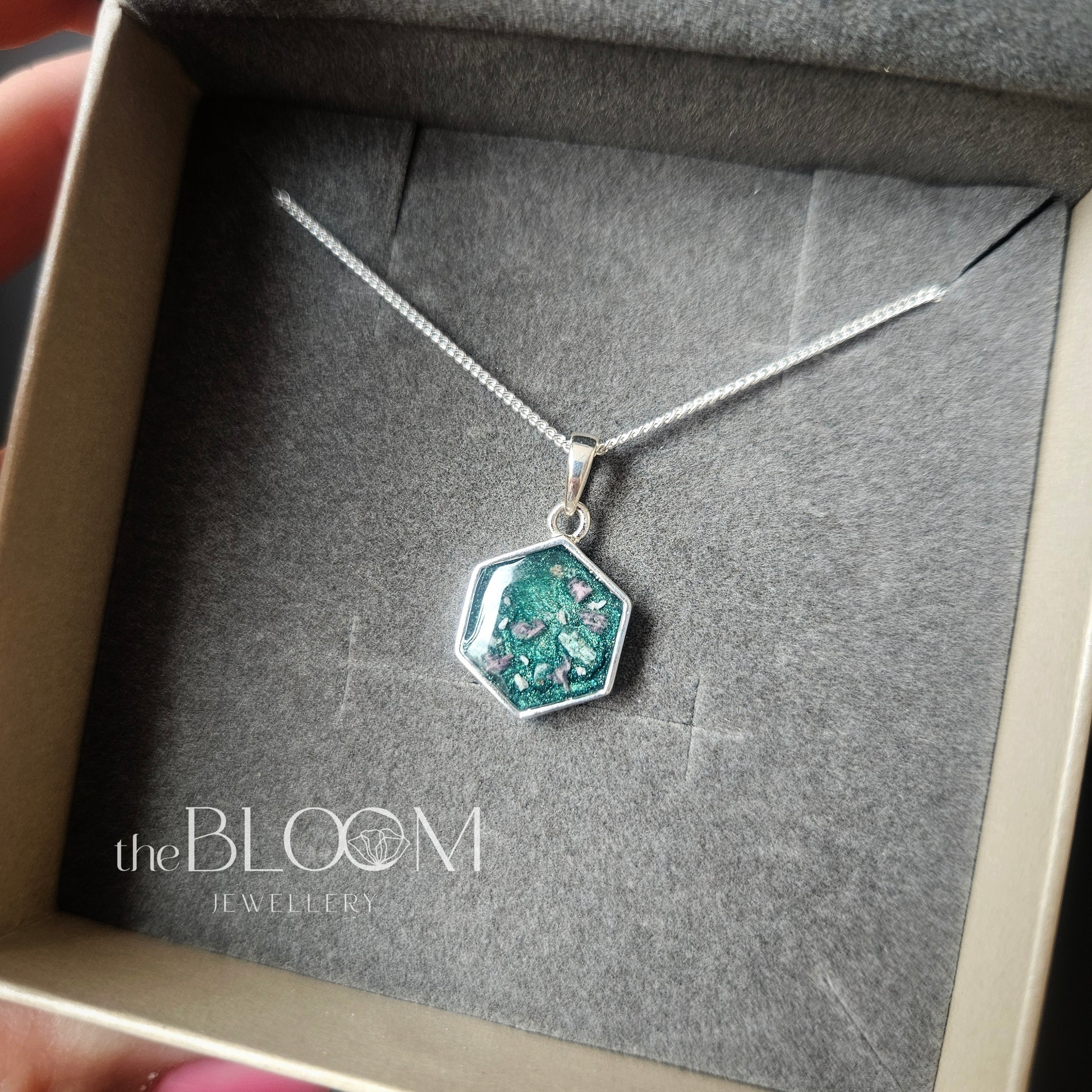 silver pendant with ashes