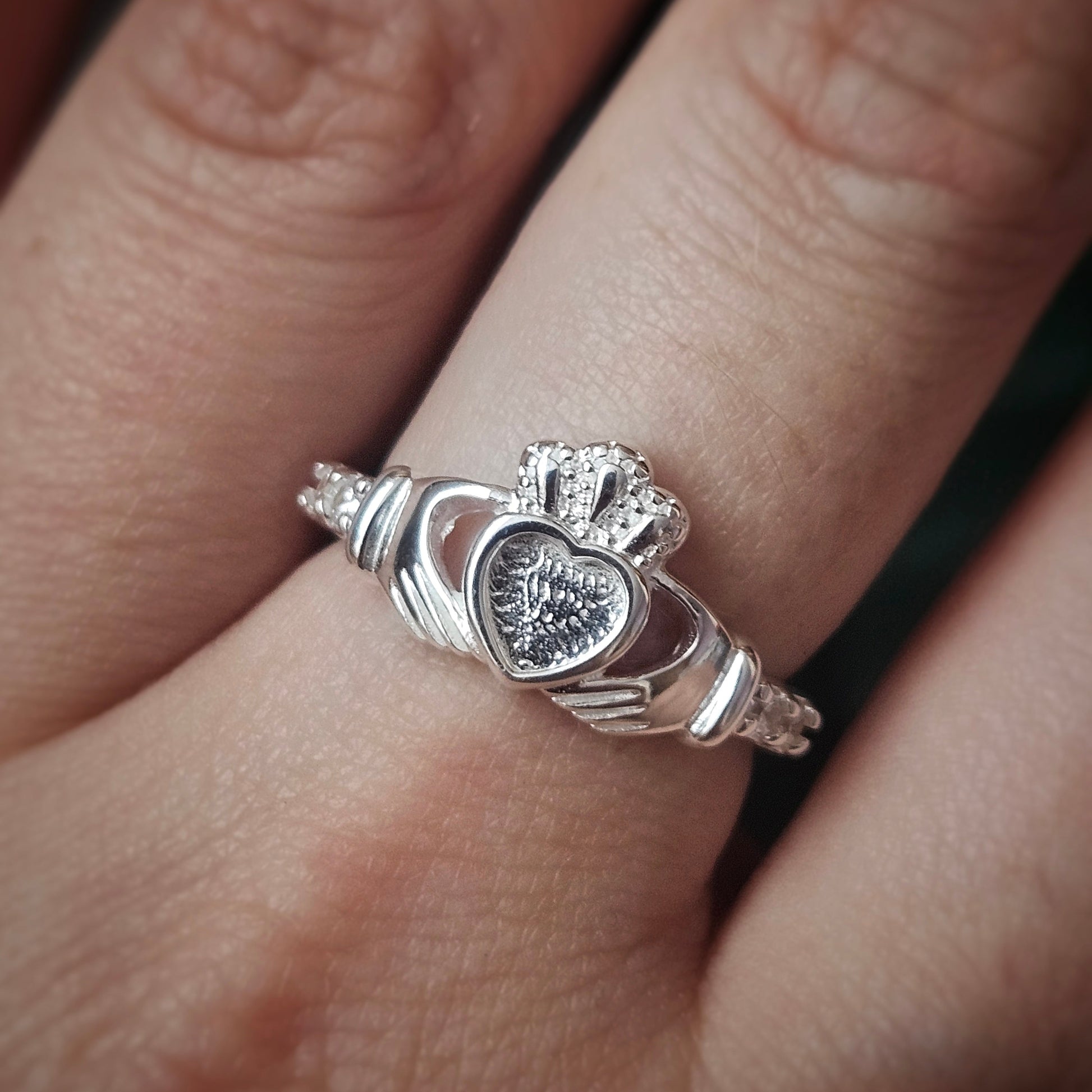 Silver Claddagh ring on a finger