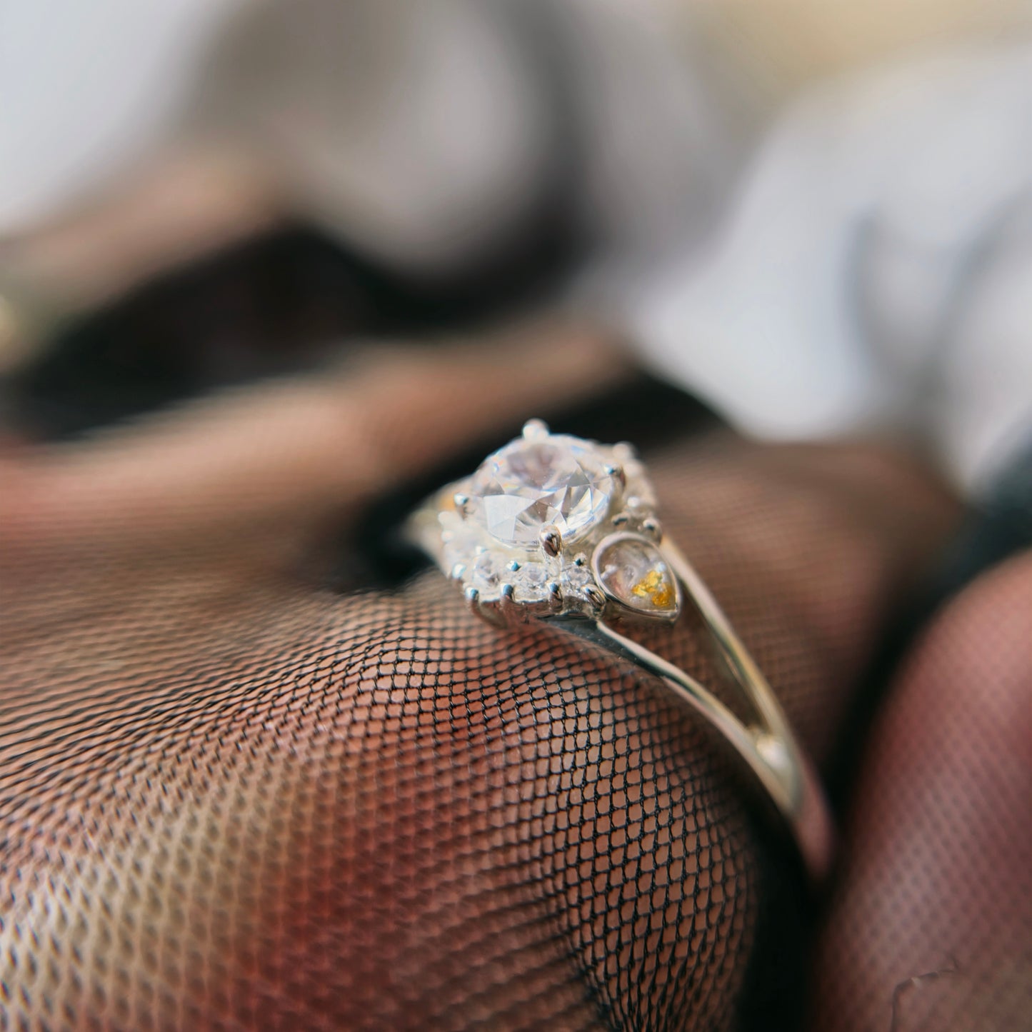 Silver ring with a diamond on a textured surface