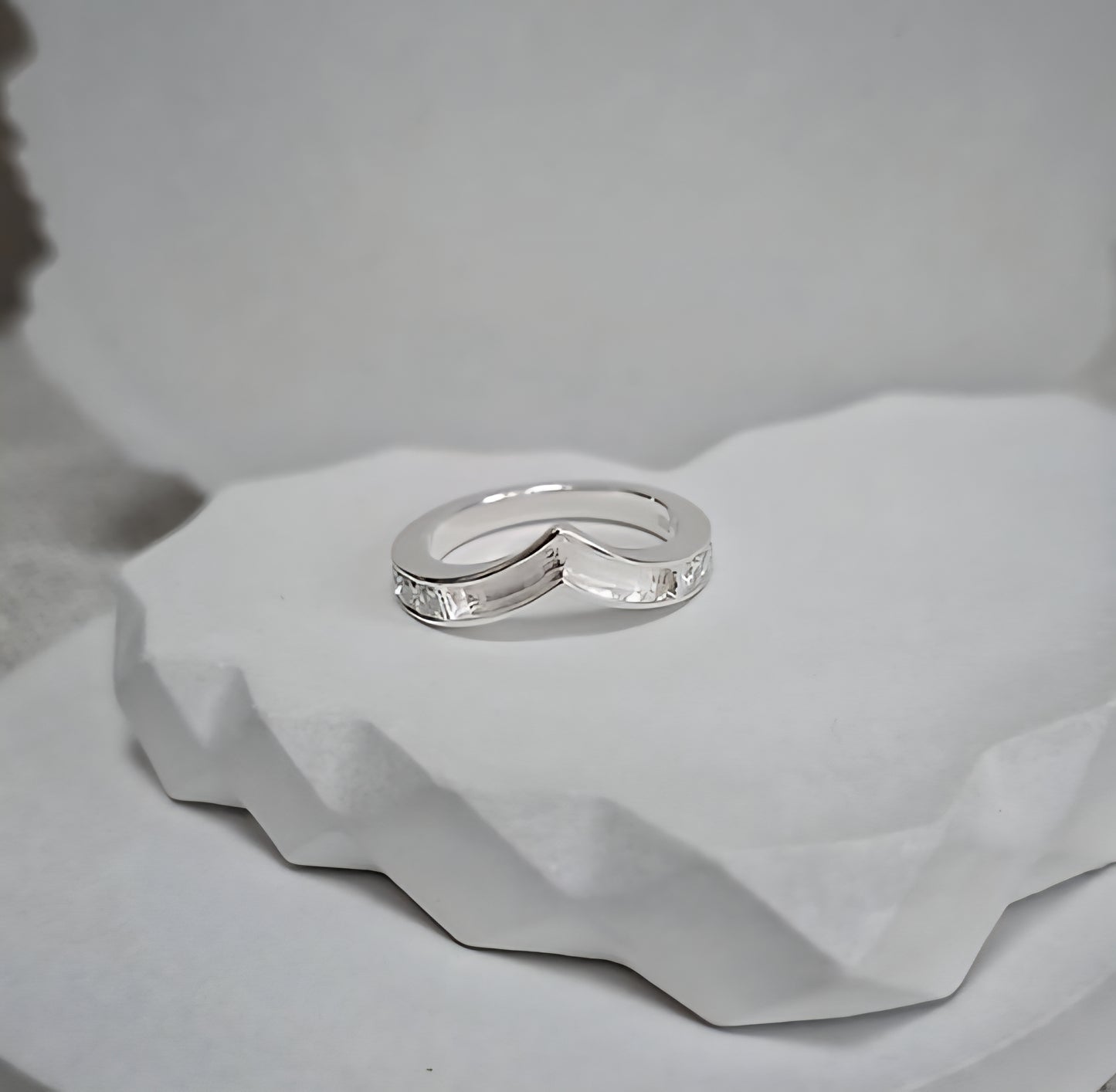 Silver ring on a textured white surface
