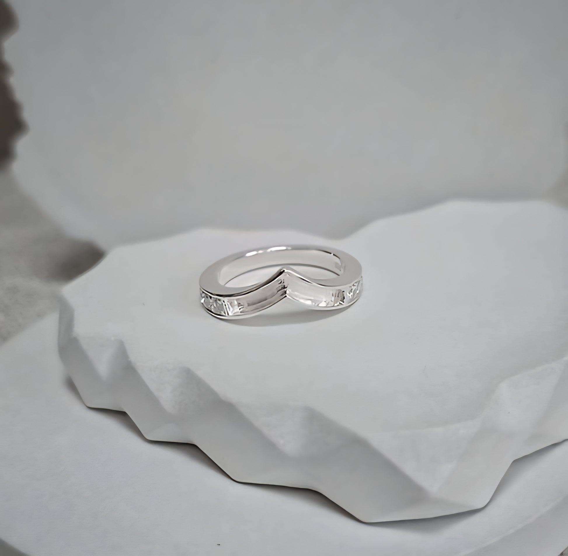 Silver ring on a textured white surface