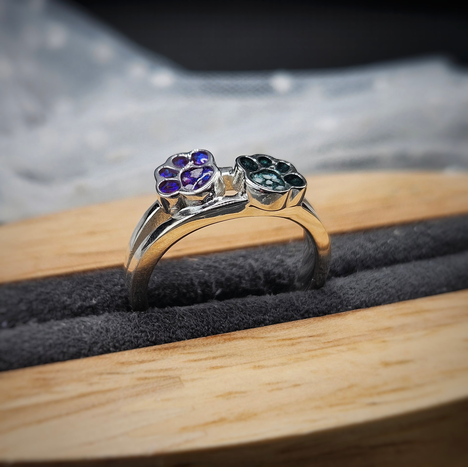 Silver ring with gemstones on a wooden surface