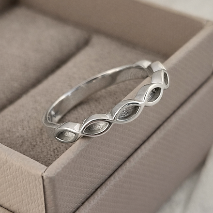 Silver bracelet with leaf design in a beige jewelry box