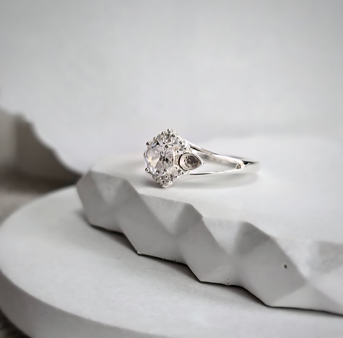 Silver ring with a cz on a white surface