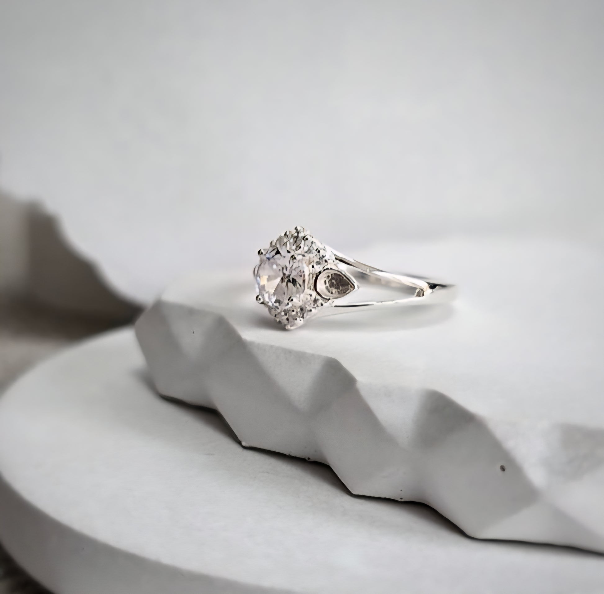 Silver ring with a cz on a white surface