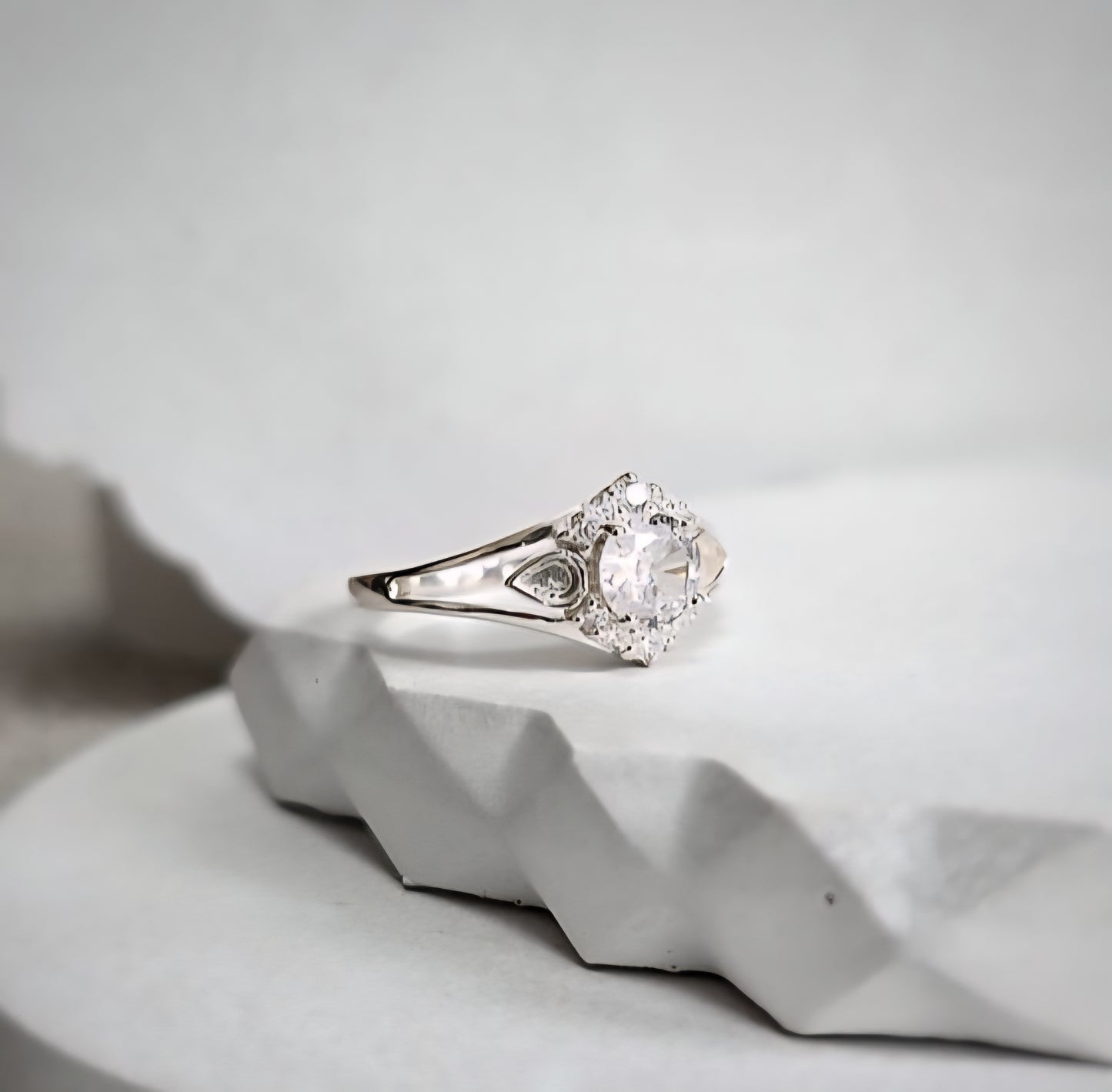 keepsake ring on a textured white surface with a light gray background