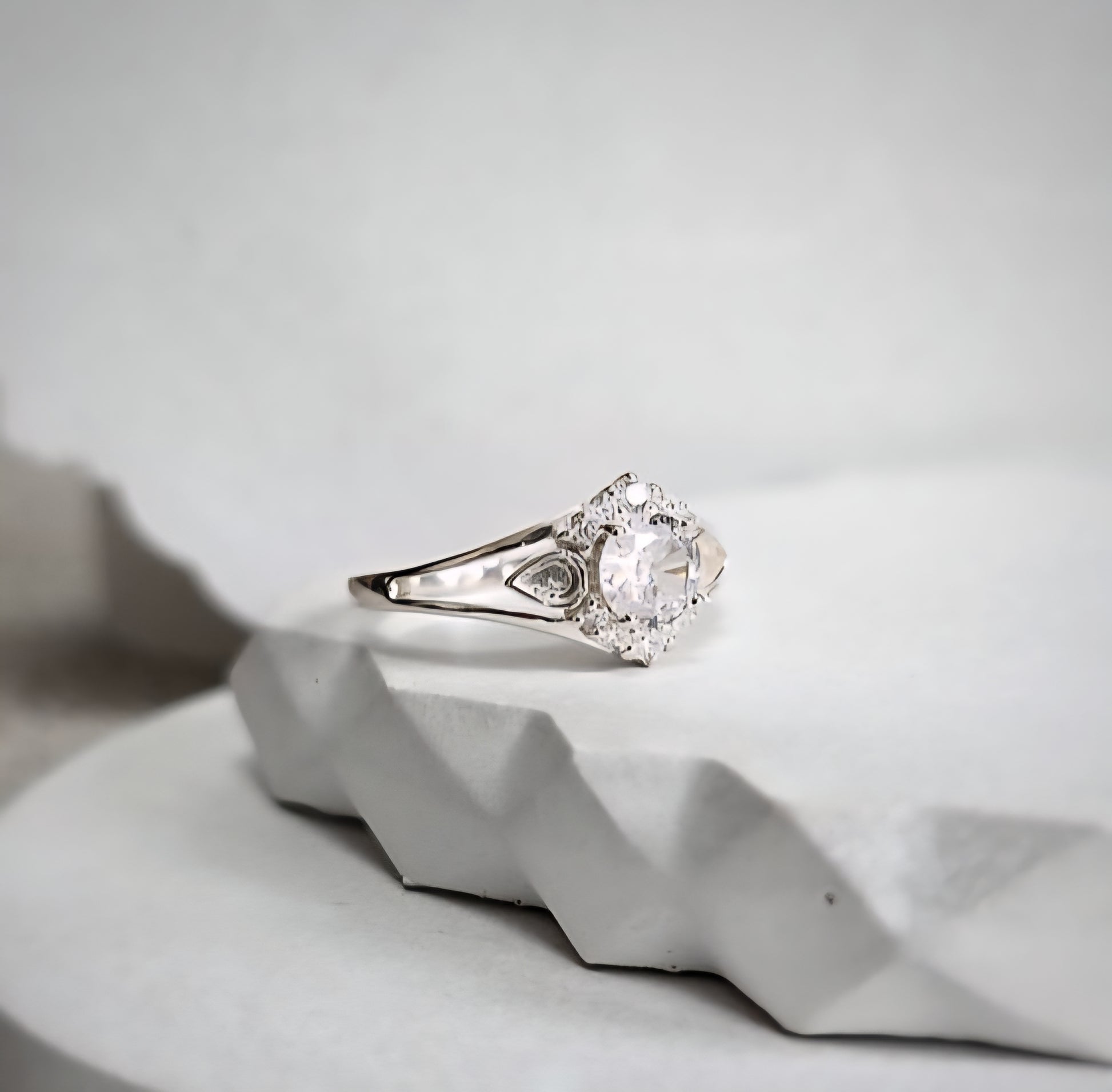 keepsake ring on a textured white surface with a light gray background