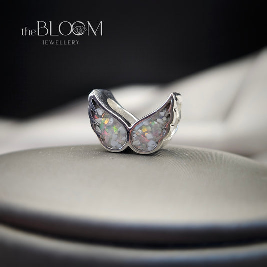 Silver ring with opal stones on a dark background, branded 'the BLOOM JEWELLERY'.
