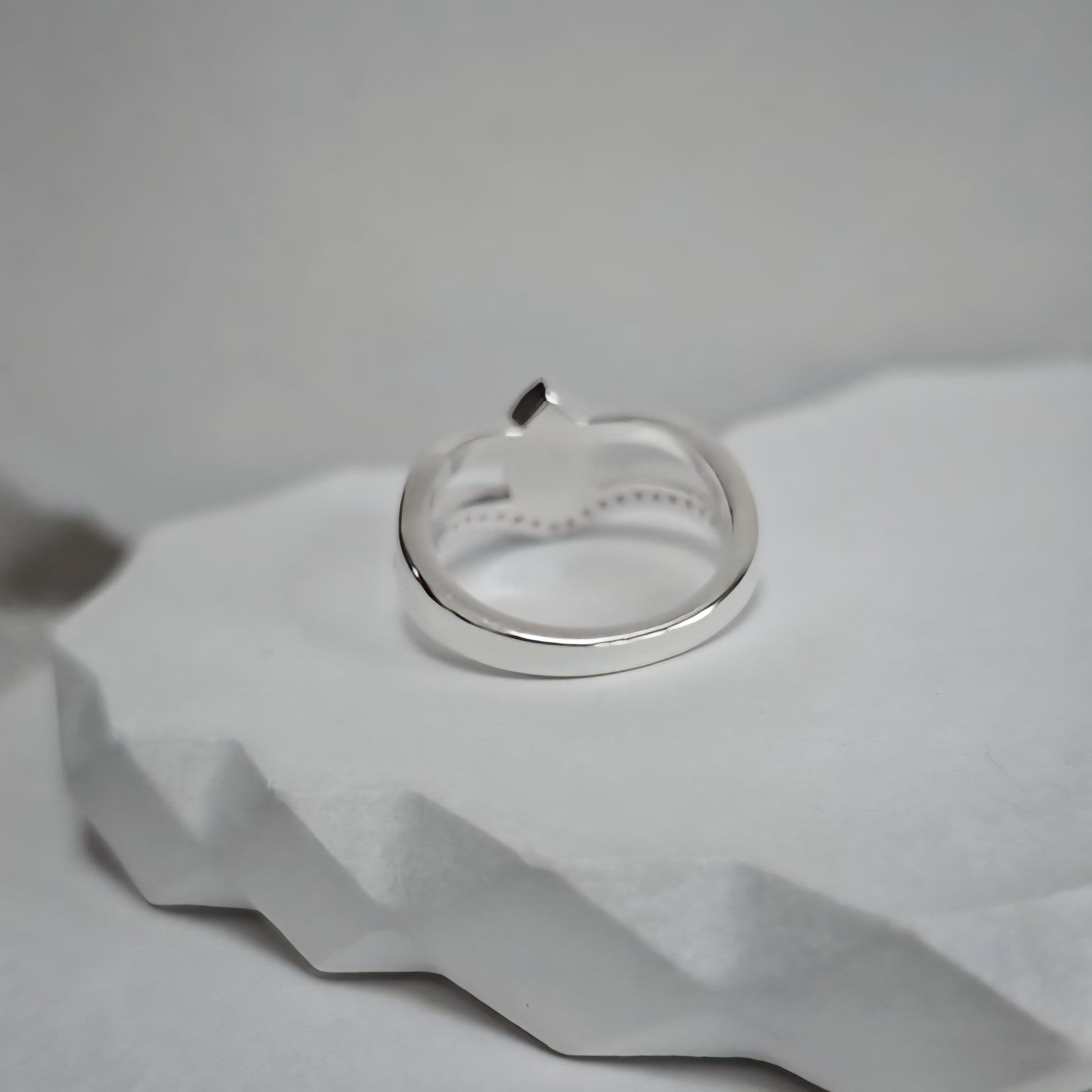 Silver ring on a textured white surface